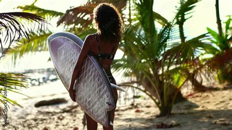 Rear View Of Attractive Surfer Girl On Beach With Surfboard Low Angle Of Woman Ass Slow Motion