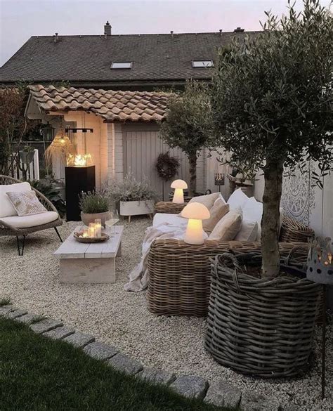 An Outdoor Living Area With Wicker Furniture And Lights On The Side Of