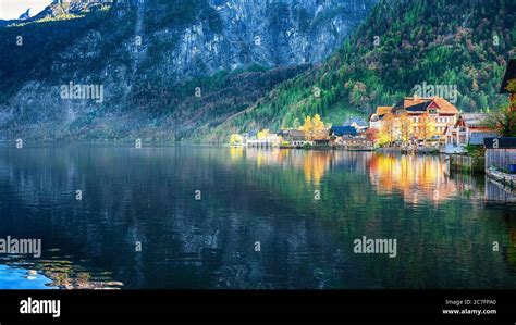 Scenic view of famous Hallstatt mountain village with Hallstatter lake. Sunnny autumn evening on ...