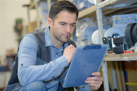 Serious Delivery Man With Clipboard In Warehouse Stock Image Image Of