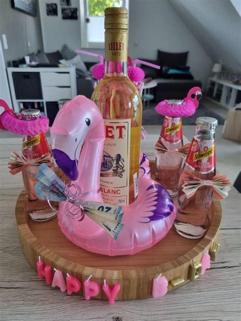 A Pink Flamingo Inflatable Wine Bottle Holder On A Wooden Table With