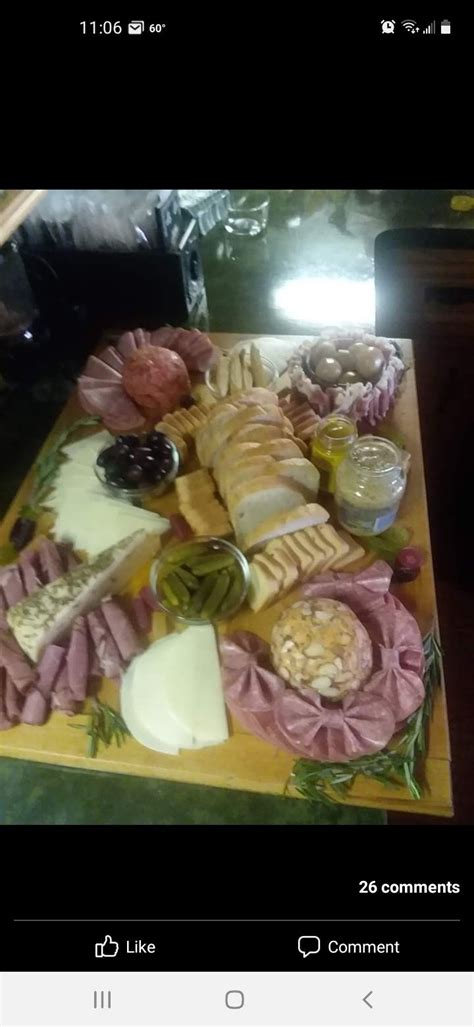 A Wooden Table Topped With Lots Of Different Types Of Cheese And