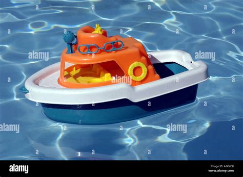 Colorful toy boat floats in swimming pool Stock Photo: 3358666 - Alamy