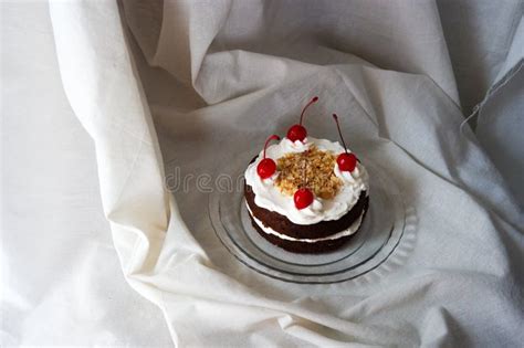 Chocolate Naked Cake With Cream Frosting And Decorated With Cherry And Peanut Stock Photo