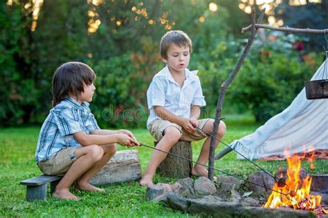 Two Sweet Children Boy Brothers Camping Outside Summertime On Stock