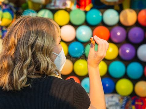 Blonde Woman Playing Pop Balloons With Darts Game Stock Image Image Of Leisure Show
