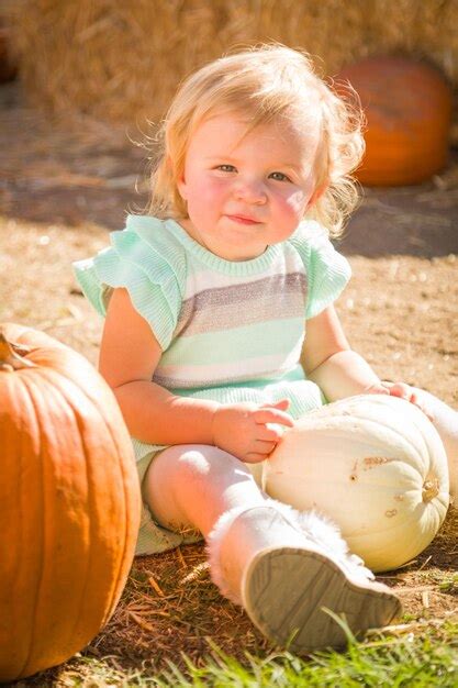 Premium Photo Adorable Baby Girl Having Fun In A Rustic Ranch Setting