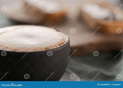 Cappuccino In Black Cup With Ciabatta Slices With Chocolate Spread On