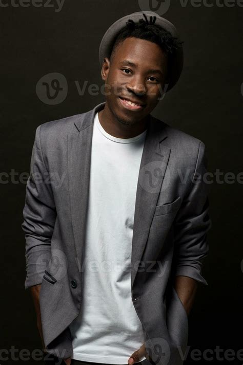 Close Up Portrait Of Handsome Black Man With Charming Smile Studio