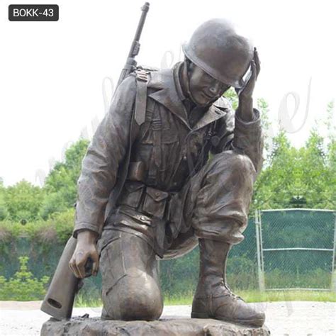 Soldier Kneeling At Cross Statue