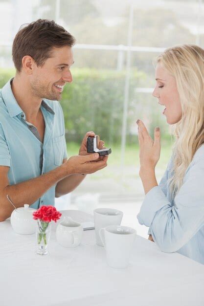 Premium Photo Man Surprising His Girlfriend With A Proposal In Cafe