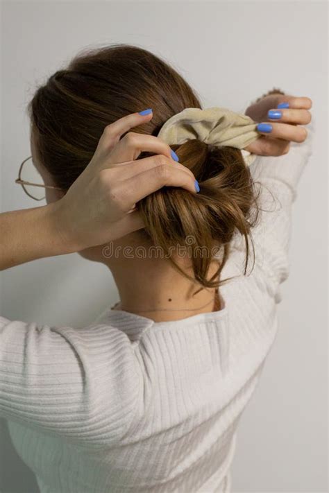 Back View of a Young Slavic Woman Styling Her Natural Dark Blonde Hair ...