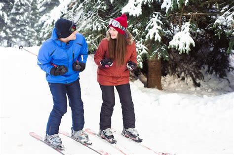 Premium Photo Happy Married Couple Skiing At A Ski Resort In The Forest