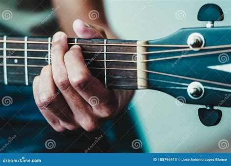 Boy`s Hand Strumming The Strings On A Guitar Neck Stock Image Image