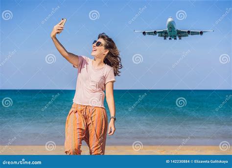 Woman Makes A Selfie On The Beach Watching The Landing Planes