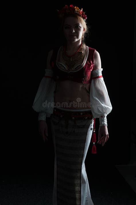 Illuminated Silhouette Of Woman In Traditional Folk Slavic Costume For