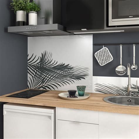 A Kitchen With Black And White Decor On The Backsplash