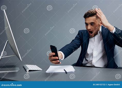 A Man In A Suit Problems At Work Sitting At A Desk In Front Of A