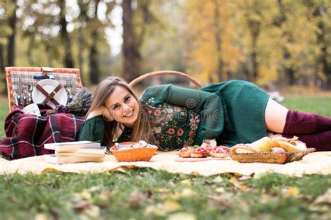 Beautiful Blonde Woman On A Picnic In The Park Laying On A Blanket Stock Image Image Of Snack