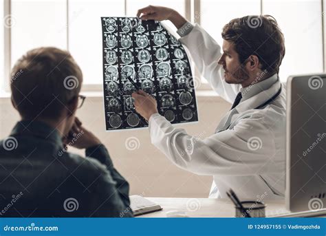 Young Doctor Showing MRI Scan of Brain To Patient Stock Image - Image ...