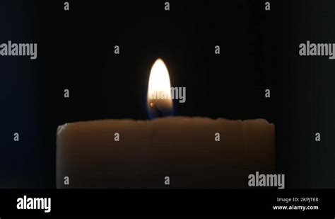 Man Blowing And Extinguishing A Lighted Candle In A Dark Room Stock Video Footage Alamy