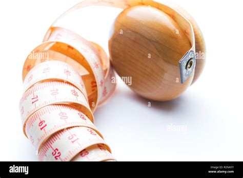 Yo-yo effect in diet concept. Wooden yoyo with centimeter measure ...