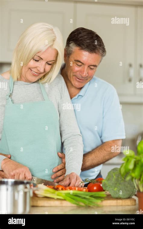 Happy Mature Couple Making Dinner Together Stock Photo Alamy