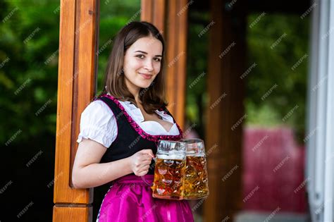 Premium Photo Sexy Russian Woman In Bavarian Dress Holding Beer Mugs