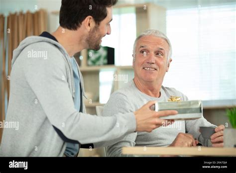 Mature Son Congratulating Elderly Father Stock Photo Alamy