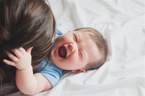 "Baby Laughing With Mom" by Stocksy Contributor "Lauren Lee" - Stocksy