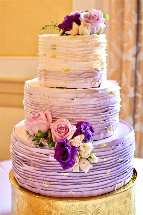 Purple ombré ruffled buttercream wedding cake with gold leaf flakes by