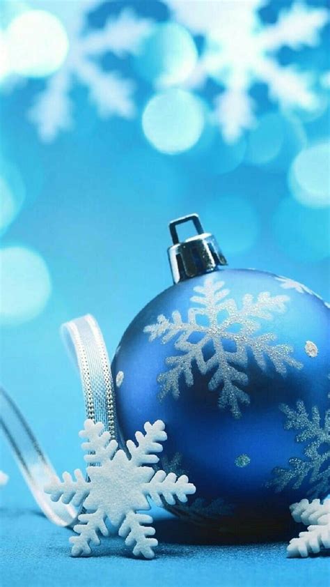 Blue Christmas Ornament With White Snowflakes And Ribbon On Bright Blue