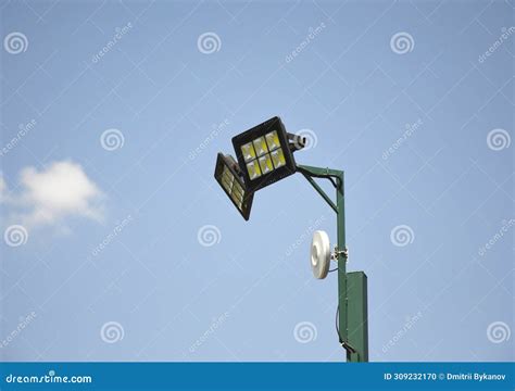 Street Lamp With CCTV Cameras On A Metal Pole Against Blue Sky Stock