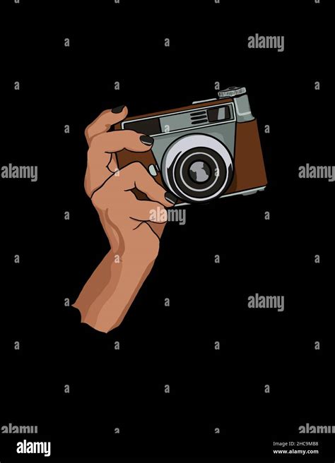 Human hand holding vintage camera and taking image - black background ...