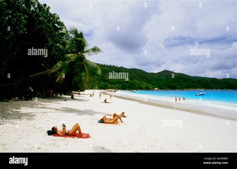 Tourists Relaxing On The Nude Topless Beach Of Anse Lazio Beach In