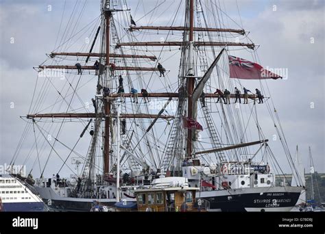 Crew Members In The Rigging Of A Tall Ship Taking Part In The Parade Of