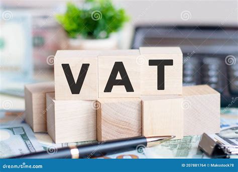 Vat Concept With Wooden Blocks And Coins On Table Business Concept