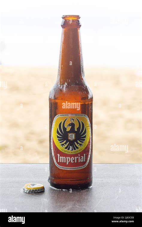 Bottle of local Imperial Beer on beach, Playa Grande, Parque Nacional ...