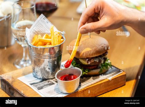 Close Up Of Hand Dipping French Fries To Ketchup Stock Photo Alamy