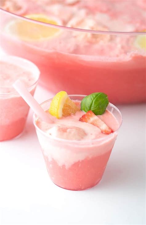 Cup Of Pink Strawberry Sherbet Punch With Lemons And Basil Sherbet