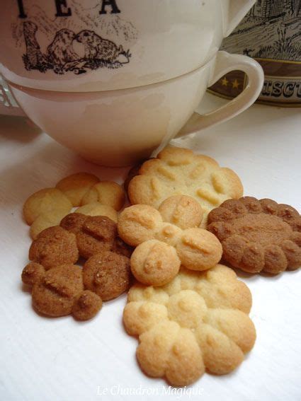 Some Cookies Are On The Table Next To A Cup