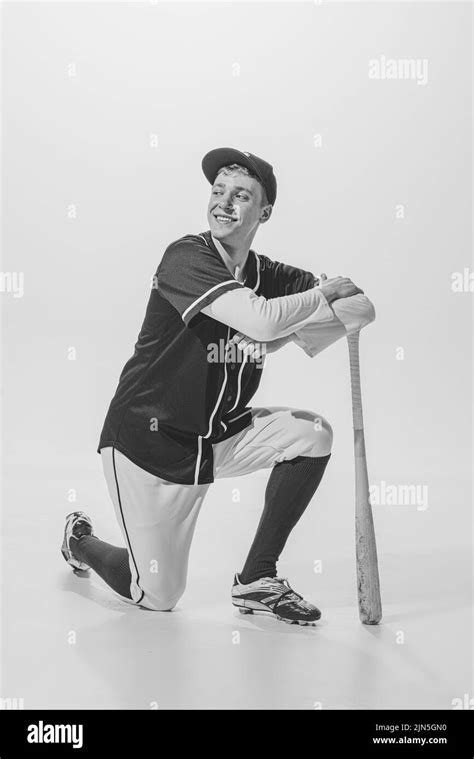 Portrait Of Young Smiling Man Baseball Player Standing On One Knee