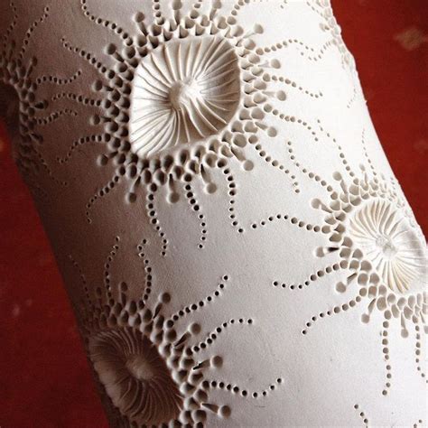 An Intricately Designed Vase Sitting On Top Of A Red Carpeted Flooring Area