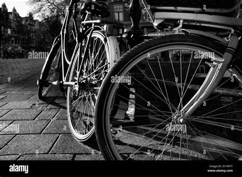 Holland Amsterdam Bicycles Parked By A Bridge Stock Photo Alamy