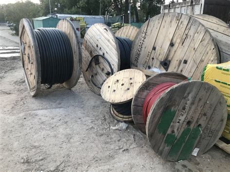 Large Spool With Black Thick Electrical Wire Or Cable Wooden Coil With