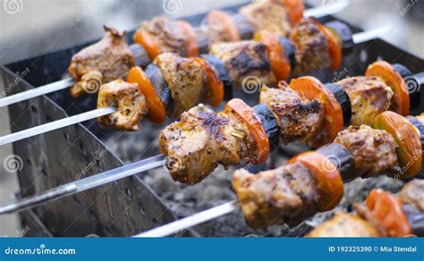 Juicy Shish Kebab From Pork Tomatoes Fried On A Fire Outdoor On A