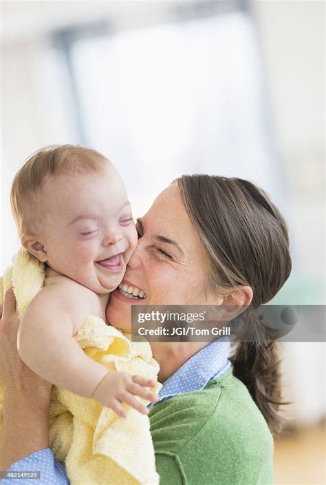 Caucasian Mother Playing With Baby Girl With Down Syndrome High Res