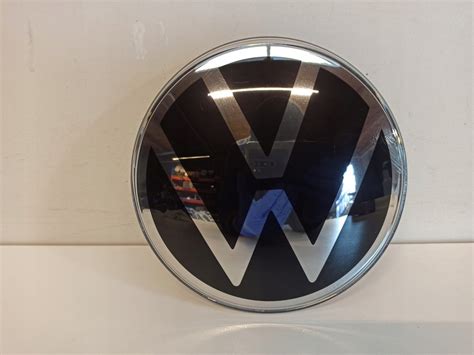 EMBLEMAT LOGO POD RADAR VW TIGUAN II 5NA853601 11972982346