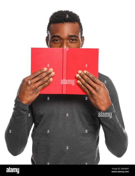 Handsome African-American man with book on white background Stock Photo ...