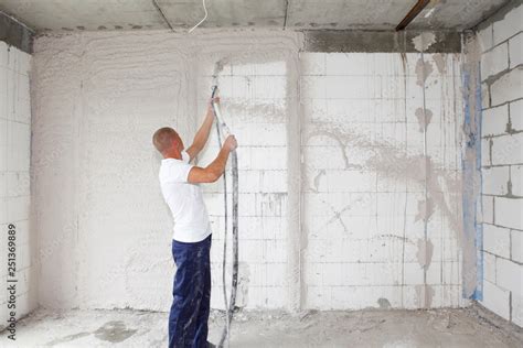 Worker Plasterer Plastering House Walls Finishing Walls With Spray